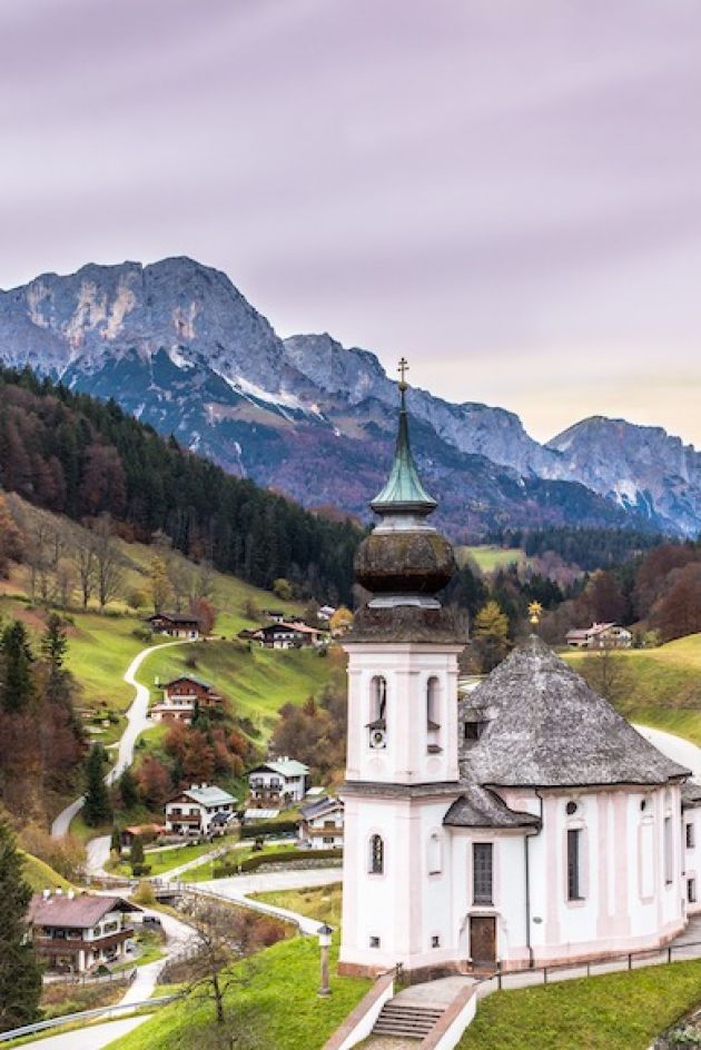 Church of Maria Gern, bavarian village and mountains on a background at sunrise. Bavarian alps.